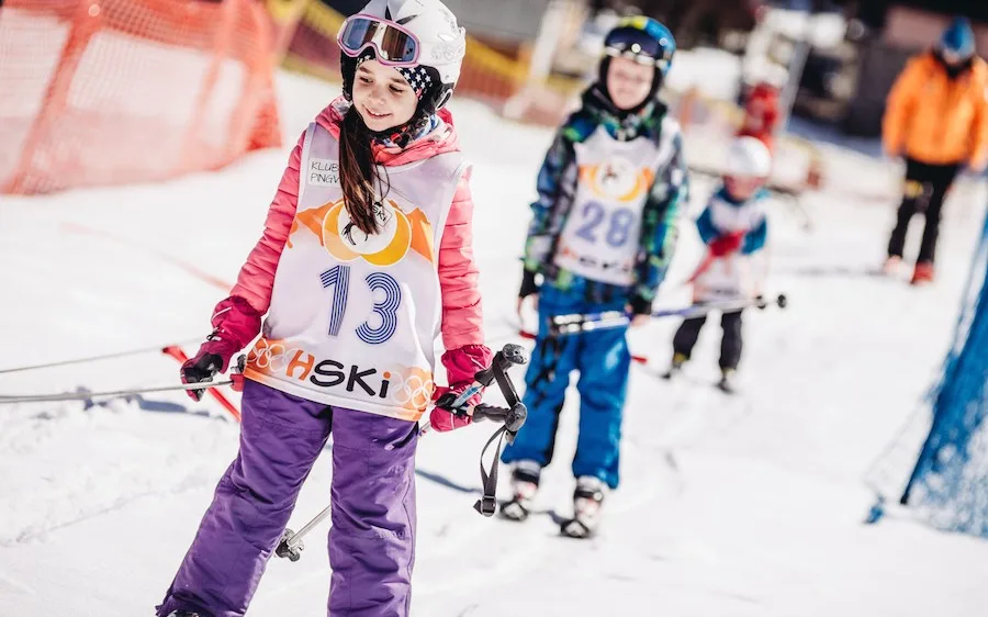 Instructor with children on skis